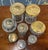 Set of 8 cut glass jars- some with pressed brass lids, some with silver lids. A few of the silver ones are marked with...