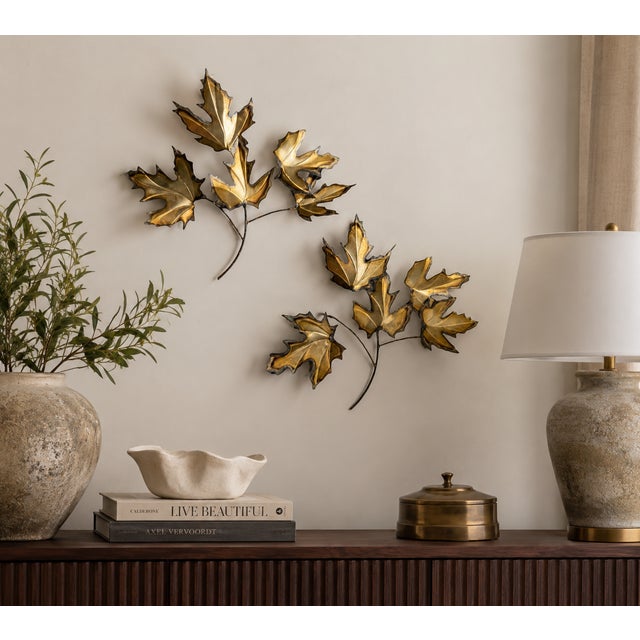 Bring warmth and sculptural interest to your walls with this beautiful pair of vintage brass-tone metal leaf wall...