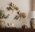Bring warmth and sculptural interest to your walls with this beautiful pair of vintage brass-tone metal leaf wall...