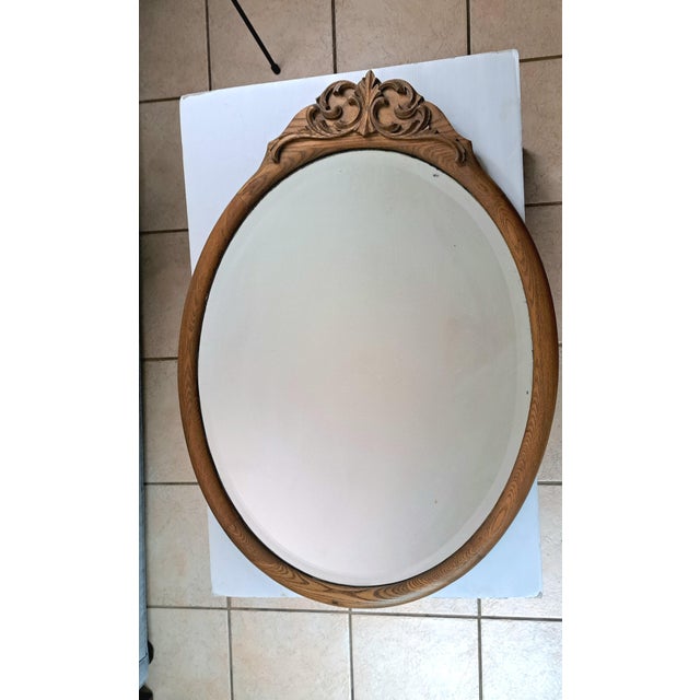 This striking late‑Victorian / Edwardian (c.1890–1920) oval wall mirror features a beautifully carved solid oak frame with...
