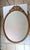 This striking late‑Victorian / Edwardian (c.1890–1920) oval wall mirror features a beautifully carved solid oak frame with...