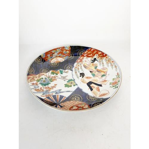 A superb large Japanese porcelain platter in the Imari style, dating from the 19th century. This richly decorated piece...
