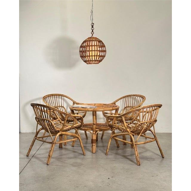 1970s rattan and bamboo living room set consisting of 4 armchairs and a coffee table (60cm high x 72cm diameter)