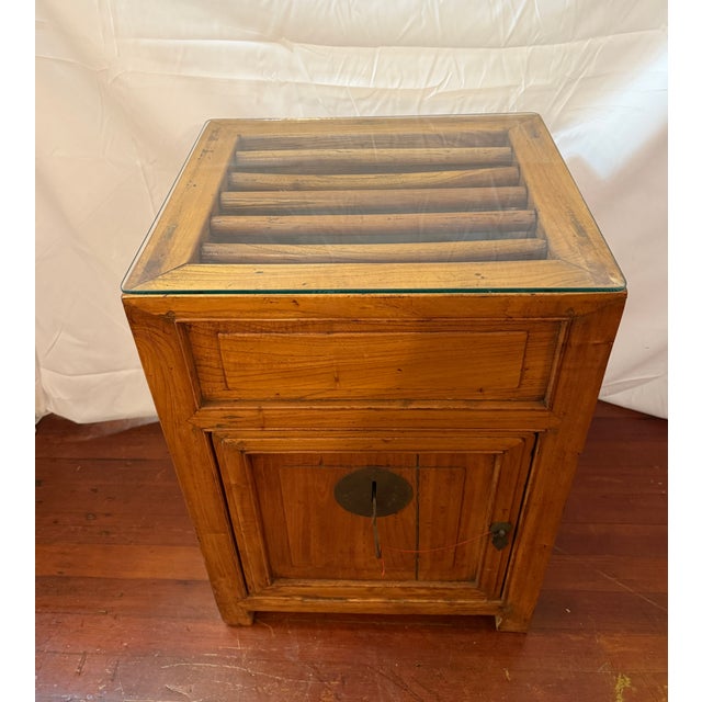An early 20th century Chinese elmwood ventilated food safe or pantry cabinet, dating to the late Qing / early Republic...