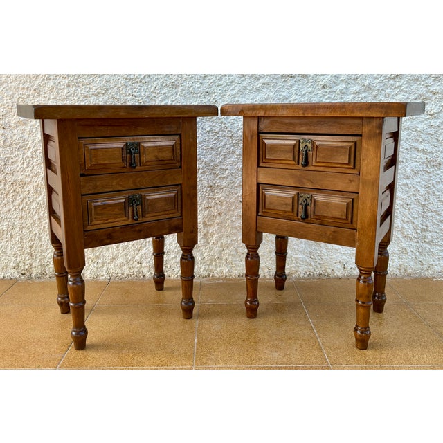 20th century pair of Spanish nightstands with two drawers and iron hardware. Beautiful tables that you can use like a...
