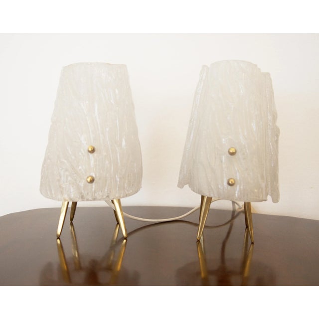 From Hotel Imperial in Vienna form the 1950s. The lamps are made from a steel constuction on brass legs for one E14 bulb....