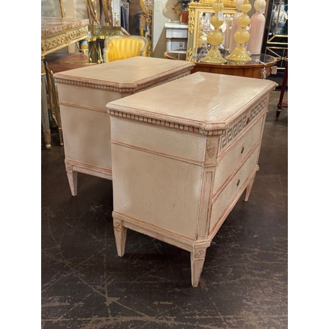 This product is a pair of Swedish Gustavian style chests of drawers with a Greek key design, showcasing a classic and...