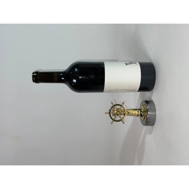 Nautical cigar cutter with a hole and cutting blade in the column. When the wheel is turned, the blade is engaged to cut...