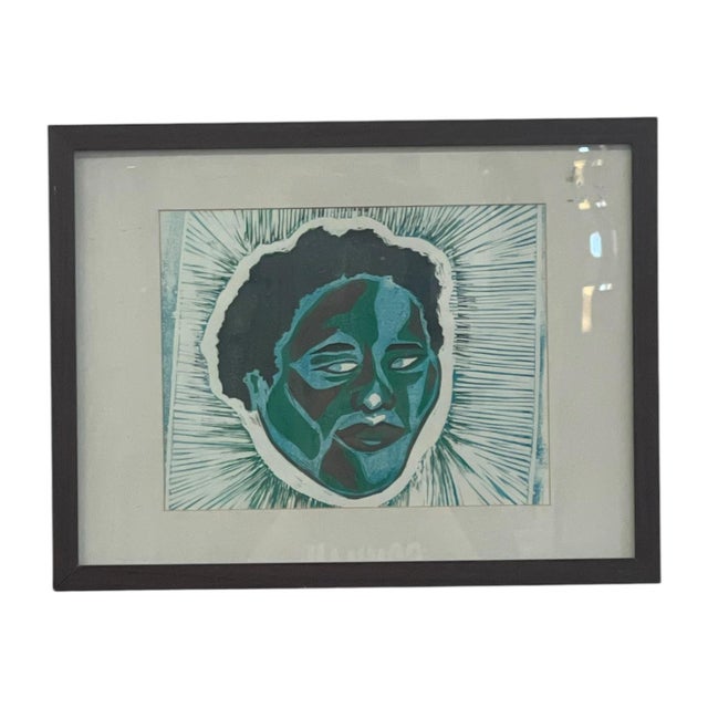Framed contemporary figurative artwork depicting a stylized portrait rendered in layered shades of blue, teal, green,...
