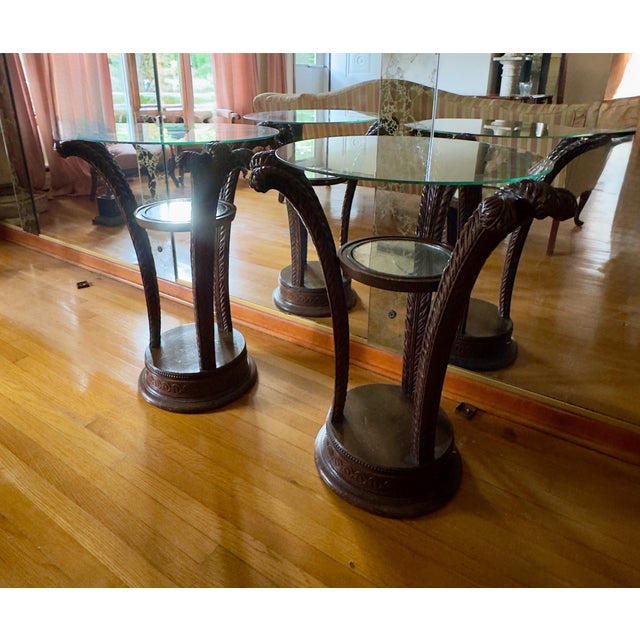 Gorgeous pair of Grosfeld tables. Pedestal base is hand carved wood plumes that curve outward to support the glass top. A...