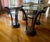 Gorgeous pair of Grosfeld tables. Pedestal base is hand carved wood plumes that curve outward to support the glass top. A...