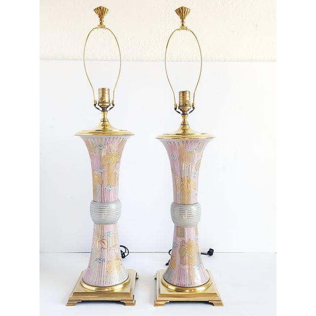 Pair of stunning Palm Beach style tall porcelain and brass fitting lamps by Wilwood. The lamp from are inspired by the...