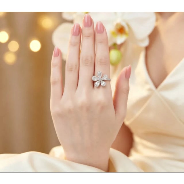 Metal: 18K White Gold Stones: Round & Baguette Diamonds1.1 CTW Design: 5-Petal Floral Flower Top Measurement: 5/8 inch...