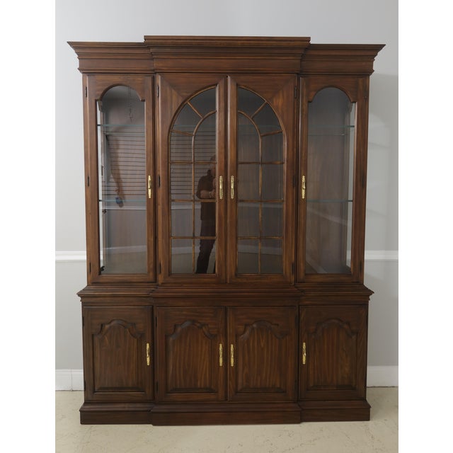 Vintage solid cherry china cabinet with 4 arched windows atop 4 raised paneled doors. This is an American-made display...