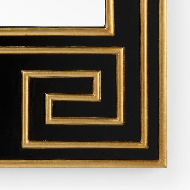 Black wood with gold leaf details and a clear beveled mirror. Designed by Bradshaw Orrell.