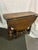 A diminutive Jacobean style Oak Gateleg Table, late 19th century, with a round top over crisply-turned supports ending in...
