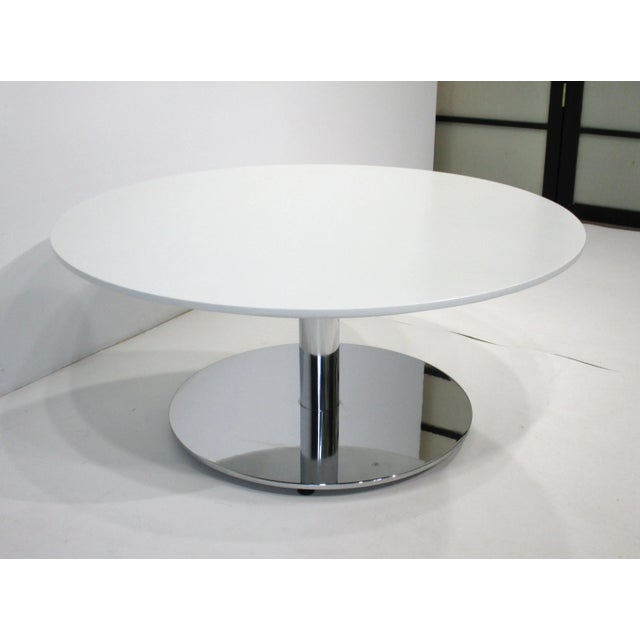 A very well-crafted chromed steel-based coffee table with round beveled edged painted wood top. Manufactured in the manner...