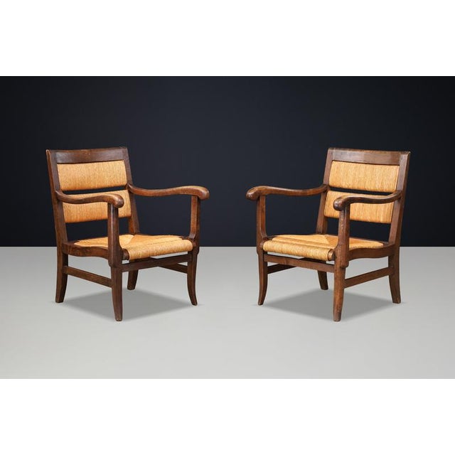 Pair of French Oak and Rush Lounge Armchairs, France, 1950s A highly characterful pair of French lounge armchairs dating...