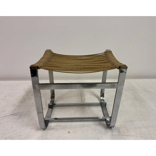 A sculptural stool attributed to Jacques Adnet, combining industrial clarity with refined handcraft. The design centres on...