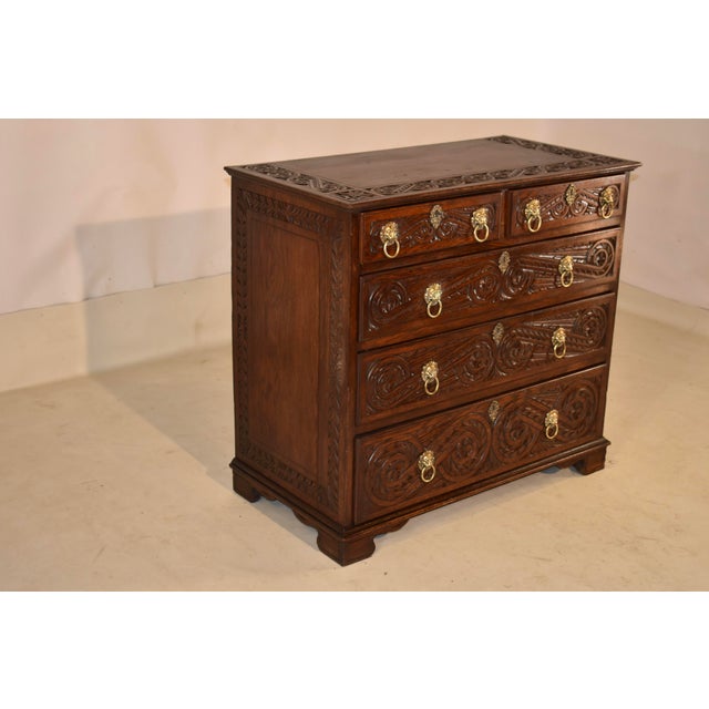 Late 18th century oak chest of drawers with hand-carved decoration from England. This is an absolute stunner! The top has...