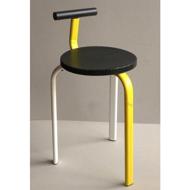 Tripod stool with a backrest, made of folded lacquered metal in yellow, white and black for the backrest and base,...