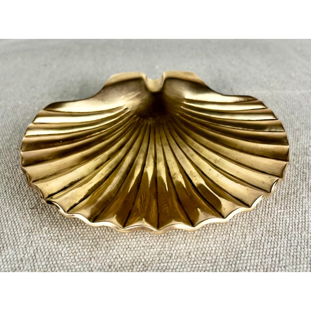Vintage brass scallop shell ashtray. Solid brass shell dish with cigarette holder indent. A great coastal nautical accent...