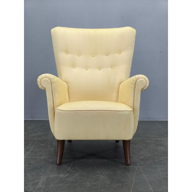 Beautiful Danish high-back wing chair produced during the 1950s. This elegant Scandinavian lounge chair embodies the...