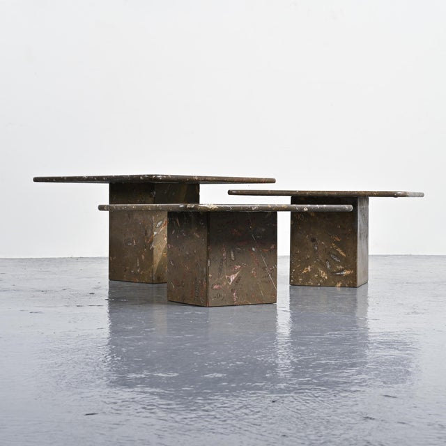 Set of three nesting tables made in Switzerland around 1970. Made of fossilized stone, they consist of square tabletops...
