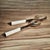 Beautifully crafted horn salad servers, each utensil features a simple shape with a finish that accentuates the horn's...
