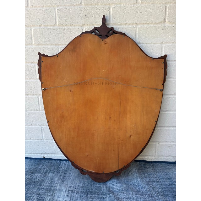 Vintage Mahogany Shield Hanging Wall Mirror. Excellent condition. H: 38 inches W: 29 inches D: 1.5 inches