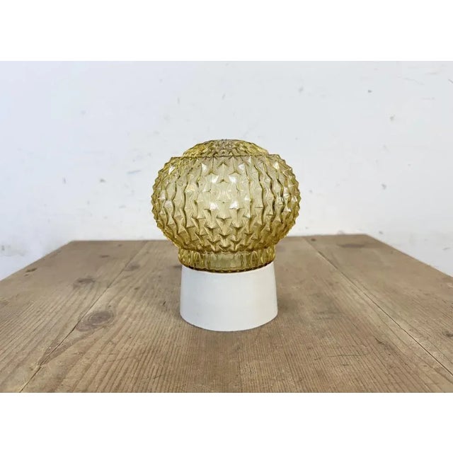 Vintage industrial ceiling or wall light made in former Czechoslovakia during the 1970s. It features a white porcelain...