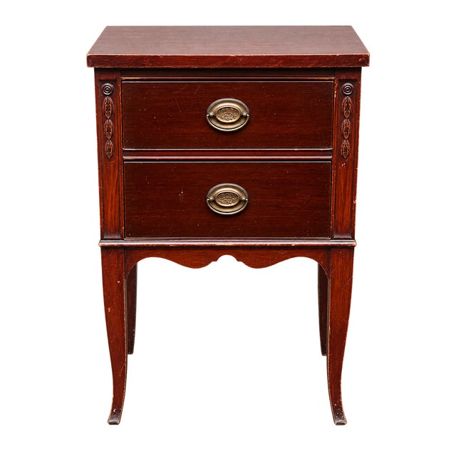 Charming matching pair of vintage two-drawer nightstands featuring a rich mahogany-tone finish, elegant proportions,...