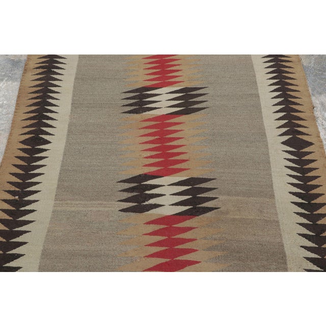 Handwoven in wool, this 4x6 antique Navajo blanket rug from the United States dates to circa 1880–1920. A classic example...