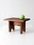 A vintage mid-century wood step stool with a simple rectangular top, warm stained finish, and arched cutouts along the...