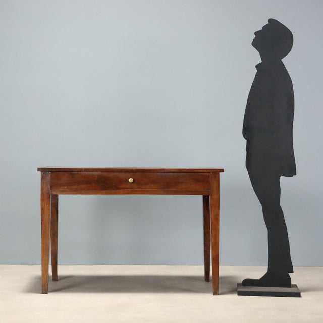 Directoire walnut desk, crafted in Italy between the late 18th and early 19th century, featuring a sober and elegant...