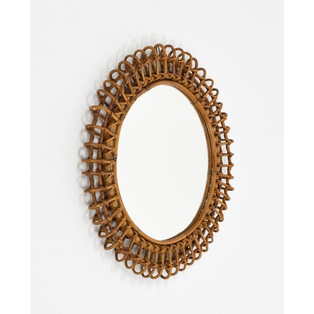 Midcentury beautiful round wall mirror framed in bamboo and rattan in the style of Franco Albini. Made in Italy in the...