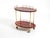 Rare 1960s Aldo Tura serving bar cart crafted from wood, clad in cherry-red goatskin and finished with a thick, clear...