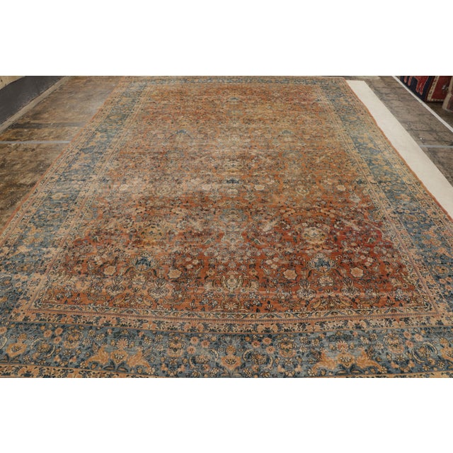 Hand knotted 10×15 antique orange-brown persian rug.