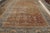 Hand knotted 10×15 antique orange-brown persian rug.