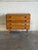This small oak dresser pairs a compact upright case with four evenly stacked drawers. Raised side edges frame the top,...