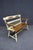 Hitchcock-style maple bench featuring a cream-painted frame, warm wood seat, and curved arms with contrasting wood...