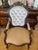 An elegant pair of Victorian Revival parlor chairs featuring richly carved dark wood frames, graceful silhouettes, and...