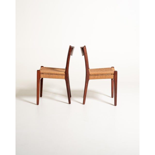 Two teak chairs with a slender frame, featuring woven rope seats and slightly curved backrests. Scandinavian production,...