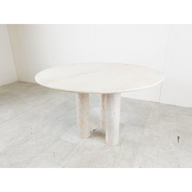 Beautiful dining table made from travertine stone with three cillindrical legs. Good looking natural travertine stone....