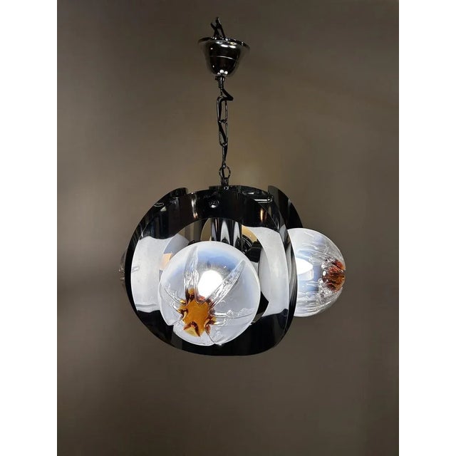 Vintage pendant light made of blown Murano glass, an Italian craftsmanship from the 1970s. The diffuser features a subtle...