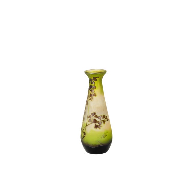 This Art Nouveau glass vase by Émile Gallé showcases botanical motifs, crafted in layered cameo glass. The vase features a...