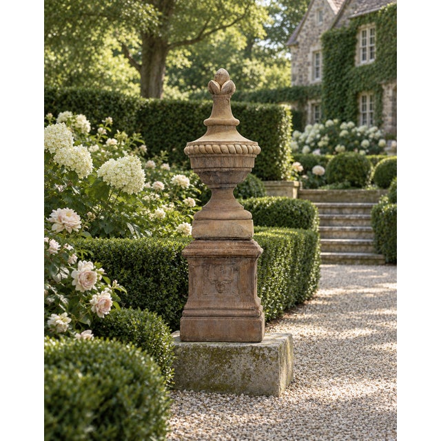A substantial two-piece Neoclassical garden finial ornament on pedestal crafted out of beautifully weathered cast stone....