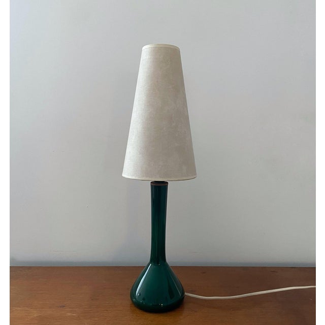 Beautiful table lamp produced by Kastrup Holmegaard, Denmark, 1960s. The lamp foot is made of organically shaped green...