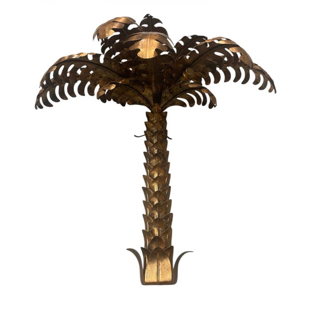 The sconce is crafted from metal with a rich, antique gold/brass finish that has developed a lovely aged patina, giving it...