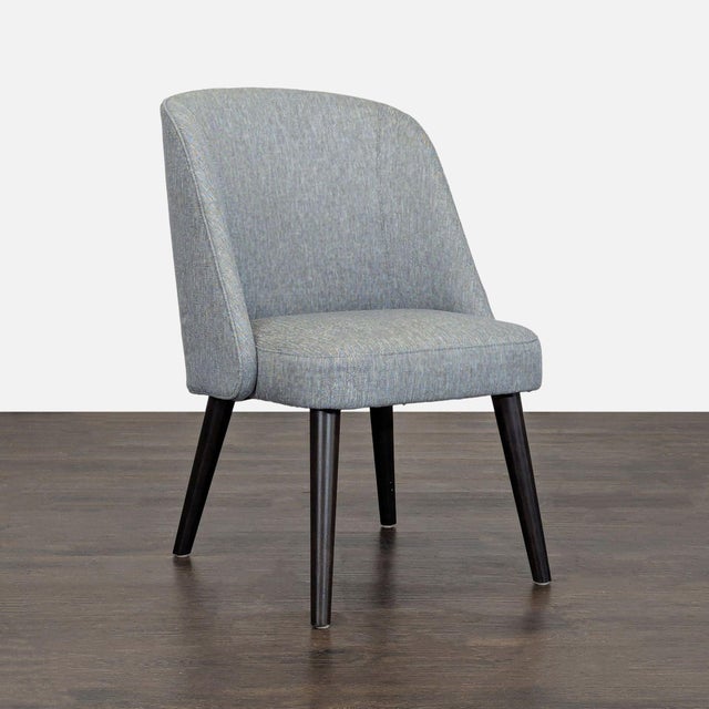 The curves of the wraparound back highlight the thin, tapered wood legs and welted fabric. Brand: Room & Board. Original...